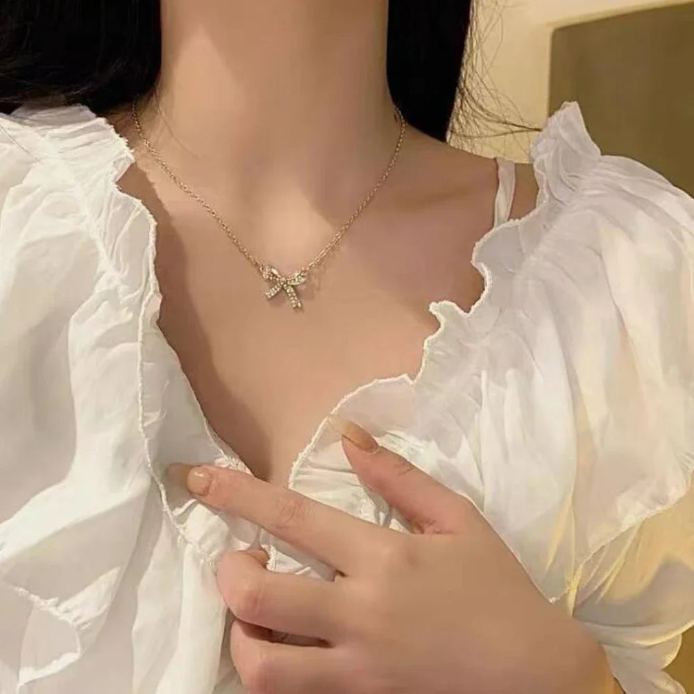 Exquisite Copper Inlaid Zirconia Bow Pendant